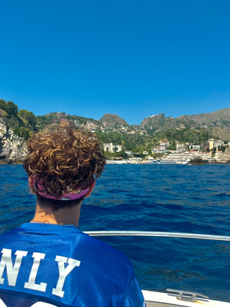 Swimmer entering bright blue coastal water