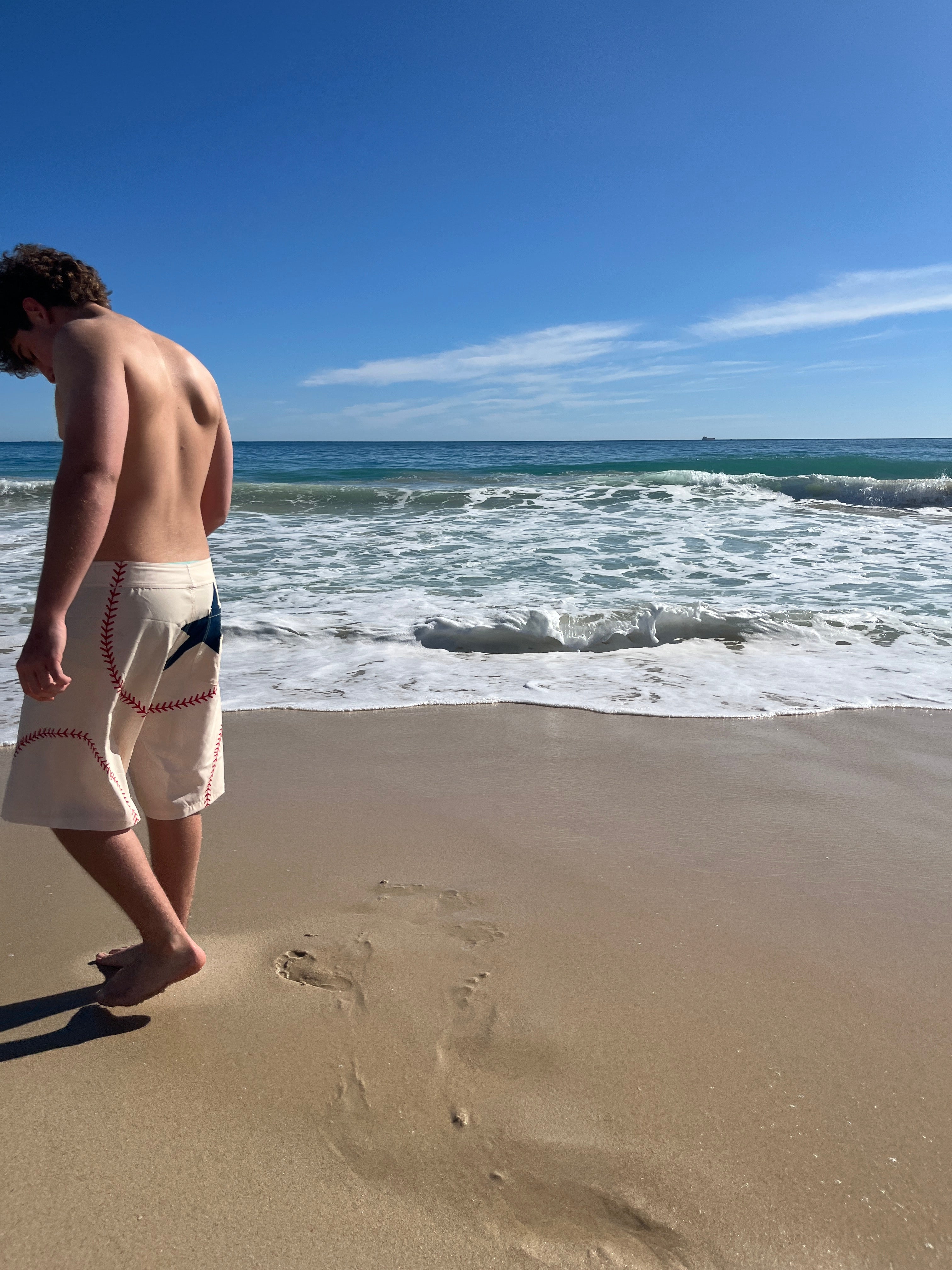 Walking beside the water in HOMERUN board shorts