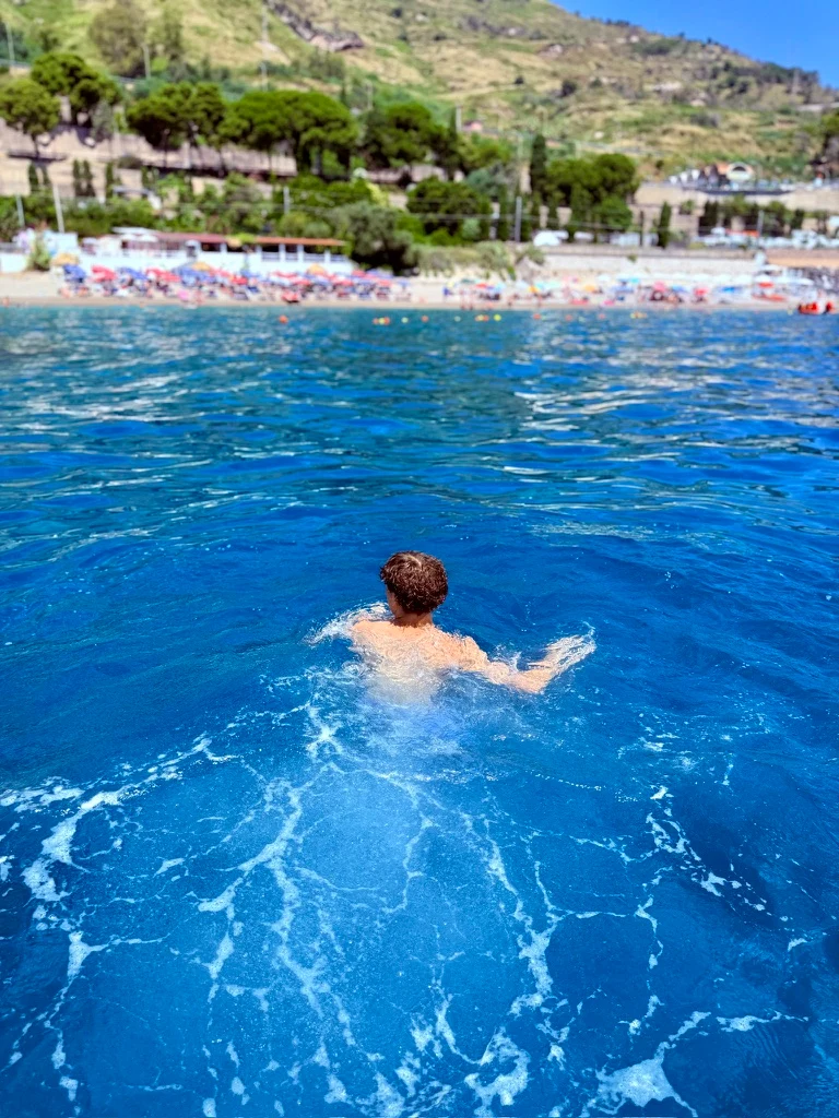 Swimming through bright blue coastal water